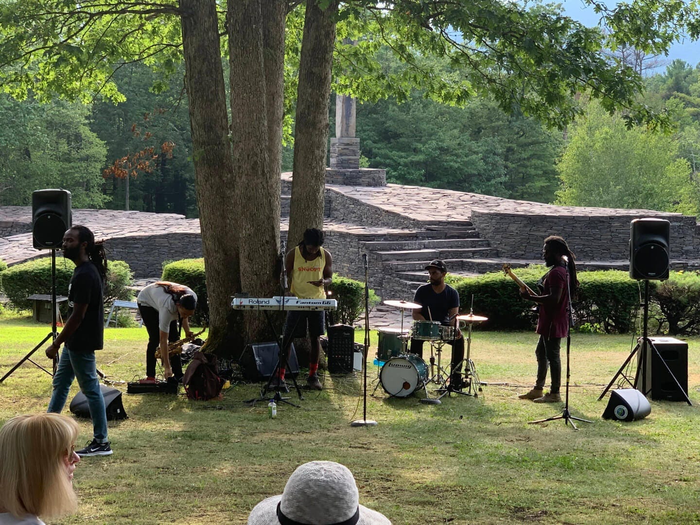 A band playing music in front of Opus 40