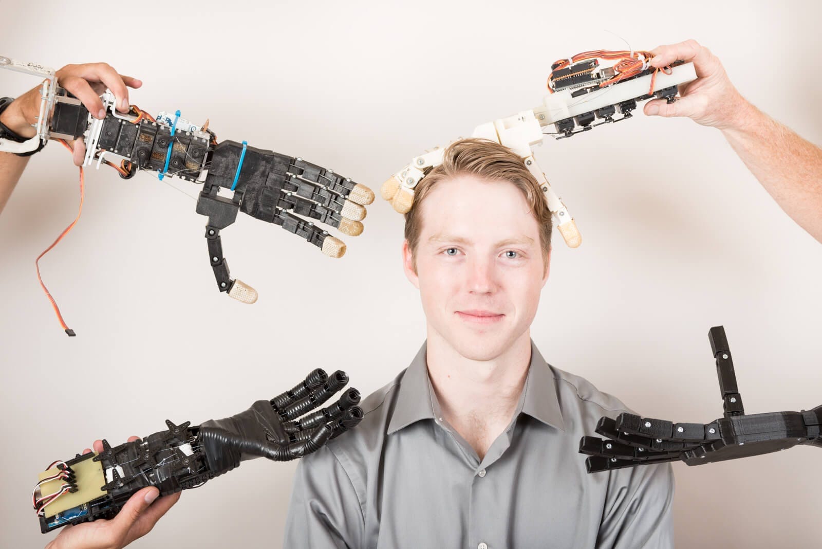 Easton LaChappelle surrounded by prosthetic hands