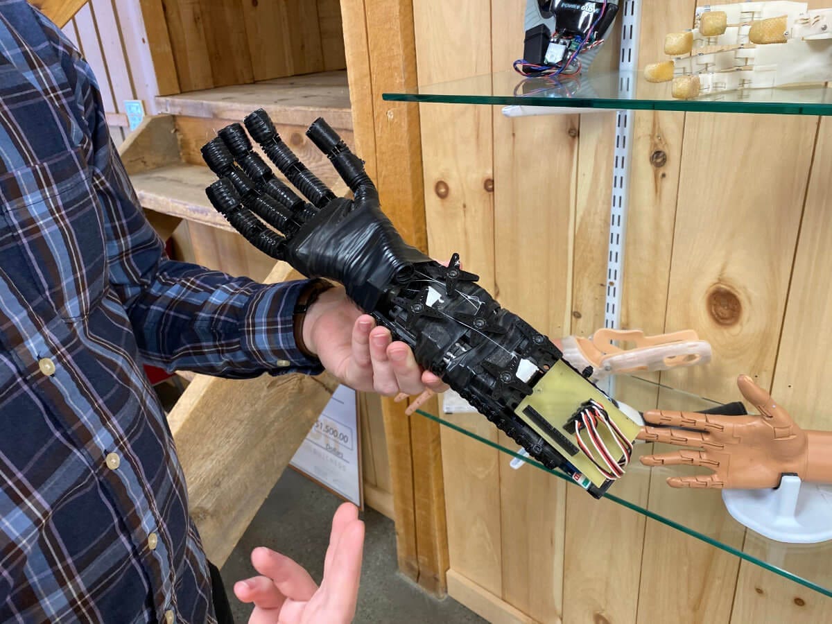 Easton LaChappelle holding an early prototype of an Unlimited Tomorrow prosthetic