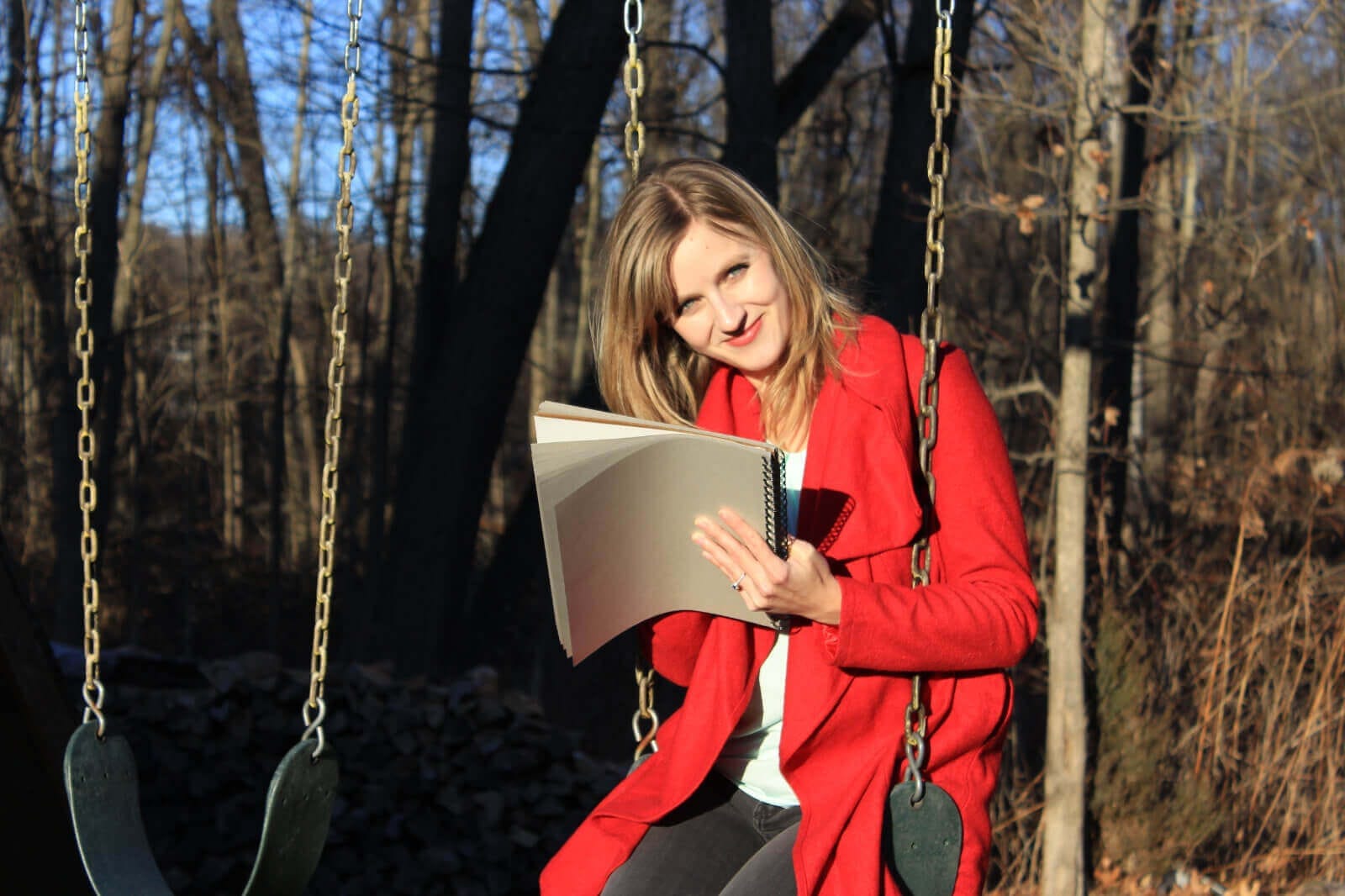 Julia Green drawing while on a swing