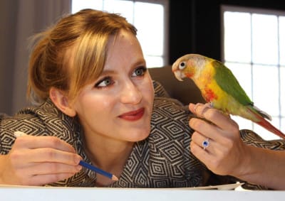 Julia Green and her pineapple conure, Pebbles